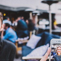 woman taking photo with phone